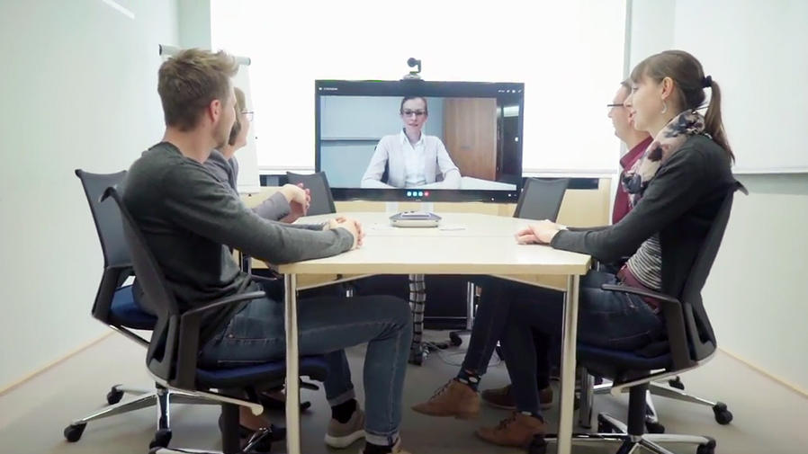 People around video conference table